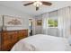 Comfortable bedroom features a wood dresser and large window with white curtains at 806 S Jersey St, Denver, CO 80224
