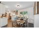 Bright dining area with modern lighting and a sliding glass door to the backyard at 806 S Jersey St, Denver, CO 80224