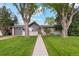 Charming single-story home with a manicured lawn, mature trees, and a welcoming walkway at 806 S Jersey St, Denver, CO 80224