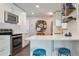 Beautiful kitchen with stainless steel appliances, quartz countertops, and cozy breakfast bar seating at 806 S Jersey St, Denver, CO 80224