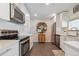 Well-equipped kitchen with stainless steel appliances, white cabinetry, and quartz countertops at 806 S Jersey St, Denver, CO 80224