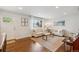 Bright living room featuring hardwood floors, neutral decor, and ample natural light through large windows at 806 S Jersey St, Denver, CO 80224