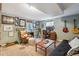 Comfortable living room featuring warm decor, cozy seating, and a personal touch with art and guitars at 806 S Jersey St, Denver, CO 80224