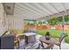 Inviting outdoor patio with comfortable seating, a fire pit table, and views of the green backyard at 806 S Jersey St, Denver, CO 80224