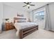 Bright bedroom features a ceiling fan, carpet floors, and a king size bed at 8051 Yampa River Ave, Littleton, CO 80125