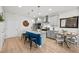 Open-concept kitchen featuring an island with a blue accent and stainless steel appliances at 8051 Yampa River Ave, Littleton, CO 80125