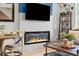 Cozy living room featuring a fireplace, stylish decor, and comfortable seating at 8051 Yampa River Ave, Littleton, CO 80125