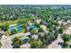 Aerial view featuring a community pool, tennis courts, pond and tree-lined streets with charming homes at 8845 W 81St Dr, Arvada, CO 80005