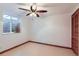 A room with a dark wooden ceiling fan and a small window and dark-stained wooden door at 8845 W 81St Dr, Arvada, CO 80005
