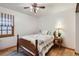 A quaint bedroom features a wooden bed frame and wood floors, alongside a window with natural light at 8845 W 81St Dr, Arvada, CO 80005
