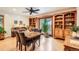 Spacious dining room with a wooden table and chairs, natural light, and hardwood flooring at 8845 W 81St Dr, Arvada, CO 80005