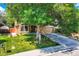 Charming single-Gathering home featuring a lush green lawn, mature trees, and a two-car garage at 8845 W 81St Dr, Arvada, CO 80005