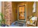Welcoming front porch featuring a decorative screen door, potted plants, and seating at 8845 W 81St Dr, Arvada, CO 80005