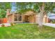 Charming brick home featuring a well-manicured lawn, brick accents, and a cozy front porch at 8845 W 81St Dr, Arvada, CO 80005