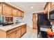Well-equipped kitchen with custom wood cabinets, quartz countertops, and modern appliances at 8845 W 81St Dr, Arvada, CO 80005