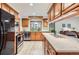 This is a kitchen with white stone countertops and natural wood cabinets, along with stainless steel appliances at 8845 W 81St Dr, Arvada, CO 80005