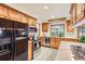 Modern kitchen with stainless steel appliances, wood cabinets, and tile backsplash at 8845 W 81St Dr, Arvada, CO 80005