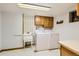 This laundry room has a utility sink and a white washer and dryer at 8845 W 81St Dr, Arvada, CO 80005