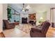 Cozy living room featuring a fireplace, large windows, and comfortable seating for a relaxing atmosphere at 8845 W 81St Dr, Arvada, CO 80005