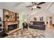 Cozy living room with a wood-burning fireplace, vaulted ceilings, and hardwood floors at 8845 W 81St Dr, Arvada, CO 80005
