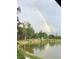Scenic view of a pond with a vibrant rainbow arching across the sky and trees, creating a peaceful setting at 8845 W 81St Dr, Arvada, CO 80005