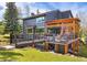 Expansive back deck with pergola, perfect for outdoor entertaining and enjoying the scenic views at 2140 Torrey Pine Dr, Evergreen, CO 80439