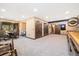 Spacious basement featuring a shuffleboard table, kitchenette and multiple doors at 2140 Torrey Pine Dr, Evergreen, CO 80439