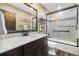 Beautiful bathroom with granite countertop, dark wood cabinets, and a tiled shower and tub at 2140 Torrey Pine Dr, Evergreen, CO 80439