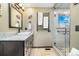 Bathroom with dark cabinets, granite countertop, shower and towel warmer at 2140 Torrey Pine Dr, Evergreen, CO 80439