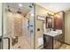 Bathroom with tiled walk-in shower and dark wood cabinet with granite countertop at 2140 Torrey Pine Dr, Evergreen, CO 80439