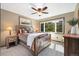 Bedroom featuring a rustic wooden bed frame, ceiling fan, and bright windows at 2140 Torrey Pine Dr, Evergreen, CO 80439