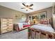 Cozy bedroom features two beds with rustic wood frames and a large window with outside views at 2140 Torrey Pine Dr, Evergreen, CO 80439