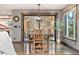 Cozy dining area with a wooden table, hardwood floors, view of the backyard, and lots of natural light at 2140 Torrey Pine Dr, Evergreen, CO 80439