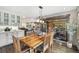 Bright dining room with a wooden table, hardwood floors, and access to the backyard, great for outdoor dining at 2140 Torrey Pine Dr, Evergreen, CO 80439