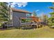 Stunning exterior view of home featuring a spacious deck with a pergola and mature landscaping at 2140 Torrey Pine Dr, Evergreen, CO 80439