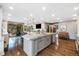 Open concept kitchen with a large island, stainless appliances, and hardwood floors, great for entertaining at 2140 Torrey Pine Dr, Evergreen, CO 80439