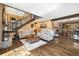 Open-concept living room has hardwood floors, a stone fireplace, and an adjacent dining area at 2140 Torrey Pine Dr, Evergreen, CO 80439