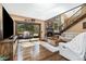 Inviting living room features a stone fireplace, hardwood floors, and sliding glass doors to the outdoor deck at 2140 Torrey Pine Dr, Evergreen, CO 80439