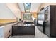 A well-lit office features a skylight, large desk, and built-in cabinets for storage at 2140 Torrey Pine Dr, Evergreen, CO 80439