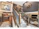 Grand staircase leads to the upper level, with views of the living area and kitchen at 2140 Torrey Pine Dr, Evergreen, CO 80439