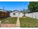 Backyard view featuring a detached garage and a small grass area with stone walkway at 3437 W 35Th Ave, Denver, CO 80211