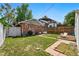 Backyard featuring lush lawn, patio area, brick home, and inviting outdoor space at 3437 W 35Th Ave, Denver, CO 80211