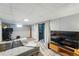Finished basement featuring a cozy sofa, television, and access to the outdoors at 3437 W 35Th Ave, Denver, CO 80211
