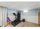 Basement area with an exercise bike and stylish sofa at 3437 W 35Th Ave, Denver, CO 80211