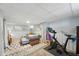 Finished basement with a exercise bike, stylish sectional sofa, and modern decor at 3437 W 35Th Ave, Denver, CO 80211