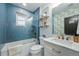 Charming bathroom with blue tile, tub shower, and patterned wallpaper at 3437 W 35Th Ave, Denver, CO 80211