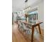 Bright dining room featuring a wooden table, modern lighting fixture, and hardwood flooring at 3437 W 35Th Ave, Denver, CO 80211