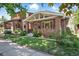 Charming brick home featuring a well-manicured lawn and inviting front porch area at 3437 W 35Th Ave, Denver, CO 80211