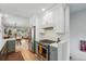Updated kitchen with white cabinets, stainless steel appliances, and hardwood floors at 3437 W 35Th Ave, Denver, CO 80211