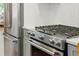 Close-up of modern stainless steel range and refrigerator in updated kitchen at 3437 W 35Th Ave, Denver, CO 80211